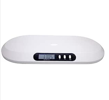 White digital baby scale with a soft mat on a table