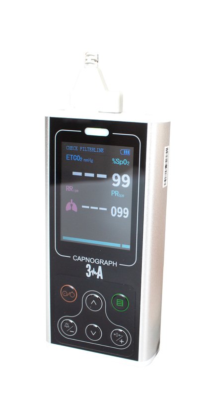 Paramedic using a handheld capnograph on a patient during transport